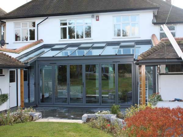 Mrs L: Caldy Wirral: Installation of Centor C1 Aluminium Bi Fold doors , Triple glazed . Marine finish Polyester Powder coated ; Roof K2 Aluminium roof system glazed in Celsius clear